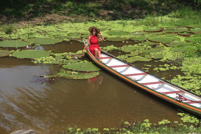 Rear view of woman kayaking in lake