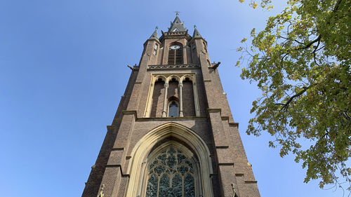 Low angle view of building against clear blue sky