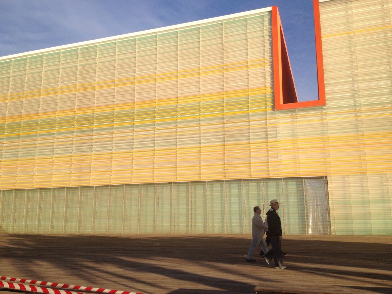 indoors, architecture, built structure, building exterior, modern, window, leisure activity, low angle view, wall - building feature, men, lifestyles, full length, day, pattern, home interior, shadow, yellow, building