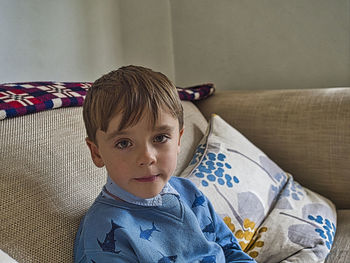 Portrait of boy on sofa at home