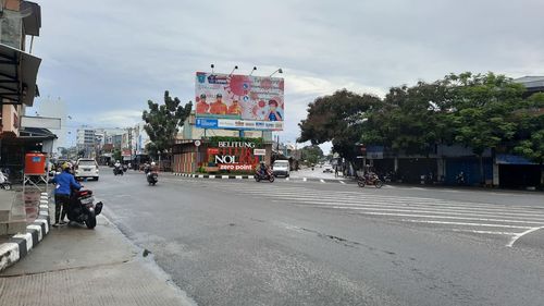 Road by city street against sky