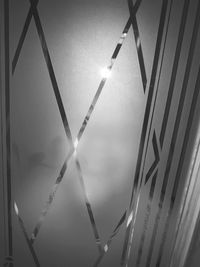 Low angle view of illuminated lighting equipment against sky