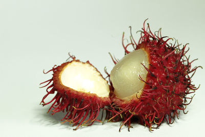 Close-up of strawberry over white background