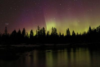 Scenic view of lake against sky at night