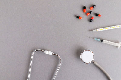 High angle view of medicines with medical equipment on table