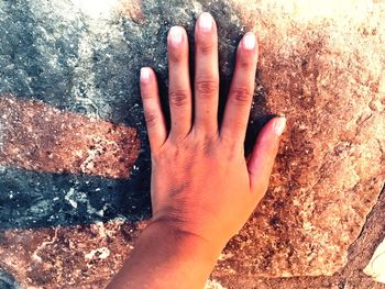 Close-up of human hand touching land