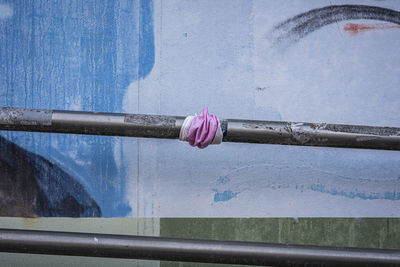 Close-up of textile on pipe against wall