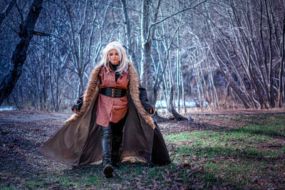 Portrait of woman standing on field