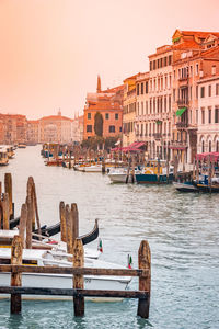 View of boats in canal against buildings