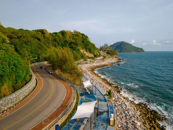 High angle view of city by sea against sky