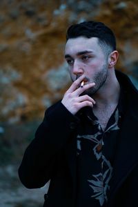 Man smoking cigarette outdoors