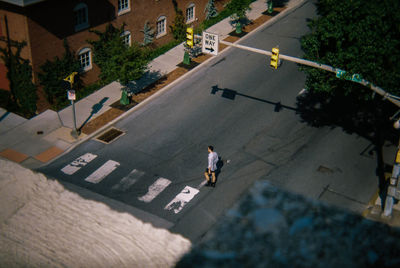 High angle view of man walking on road