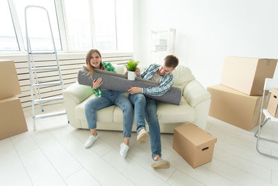 Young couple sitting in box