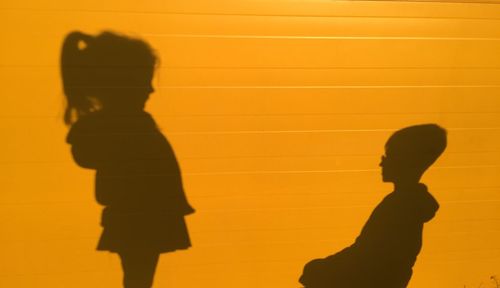 Shadow of children on wall