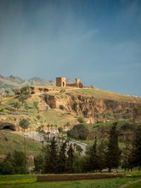 Built structure on landscape against sky