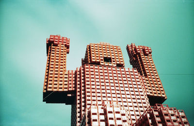 Low angle view of crate statue against sky