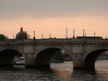 Bridge over river at sunset