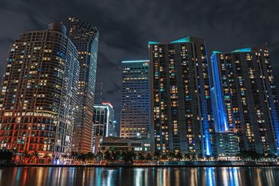 Low angle view of skyscrapers lit up at night