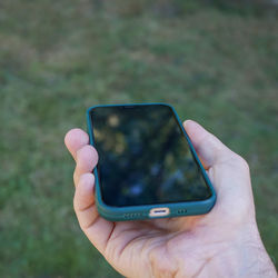 Cropped hand of woman using mobile phone