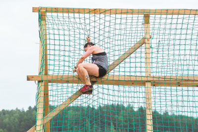 Low angle view of man skateboarding on fence