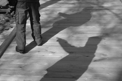 Low section of woman walking on floor