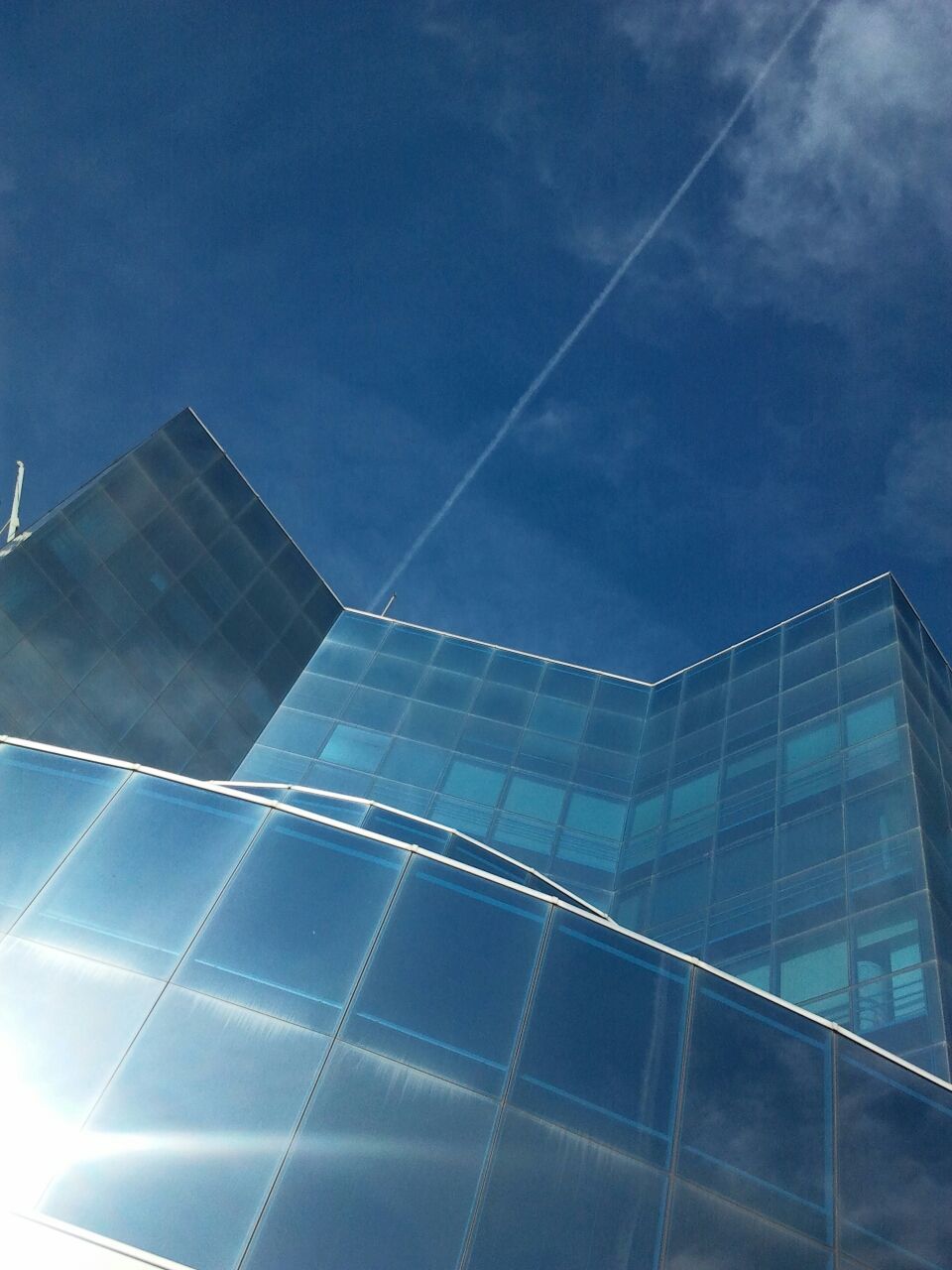 architecture, built structure, building exterior, blue, low angle view, modern, sky, city, office building, reflection, glass - material, pattern, cloud - sky, skyscraper, building, outdoors, no people, day, tall - high, cloud