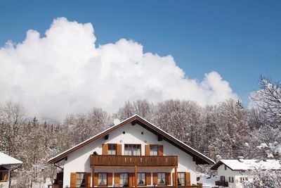 Houses and buildings against sky during winter