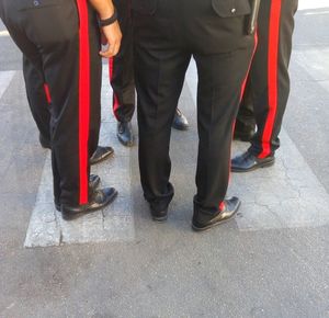 Low section of people walking on road