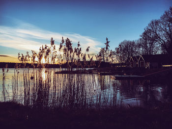 Scenic view of lake against sky at sunset