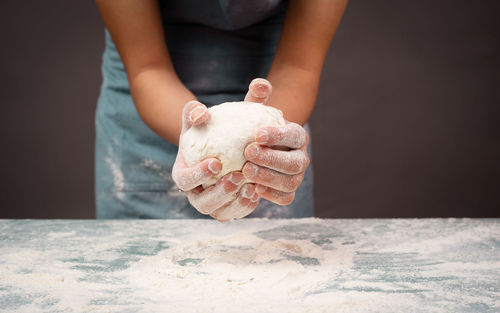 Baker kneading dough for pizza or artisan bread, prepare ingredients for food, baking pastry
