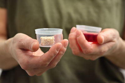 Midsection of man holding ice cream