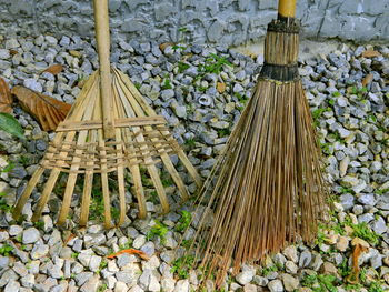 Close-up of brooms and rakes made from bamboo and coconut stalks