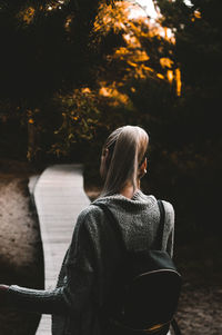 Rear view of woman sitting outdoors