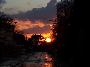 Road against cloudy sky at sunset