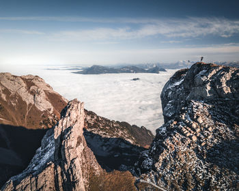 Rock formations by sea against sky