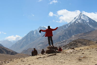 Man standing on mountain road against sky