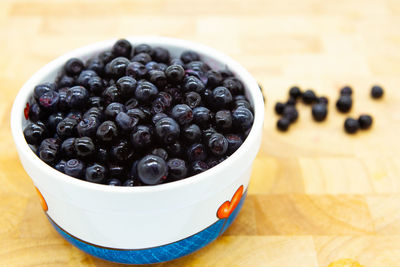 High angle view of black fruits in bowl on table