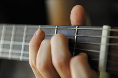 Close-up of hand playing guitar