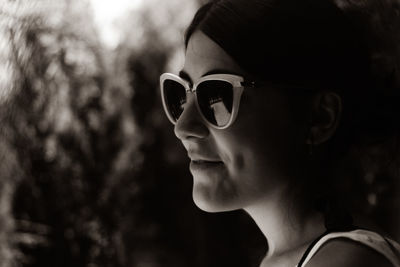 Close-up of woman wearing sunglasses outdoors