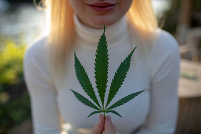 Close-up of woman holding marijuana