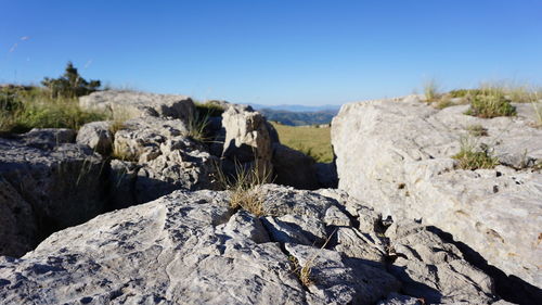 Close-up of rock formation against clear sky