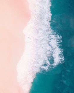 Close-up of wave on beach against sky