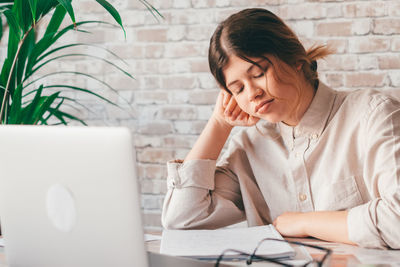 Young woman using laptop at office
