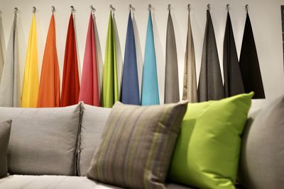 Close-up of multi colored umbrellas hanging on sofa