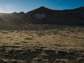 Scenic view of arid landscape against sky