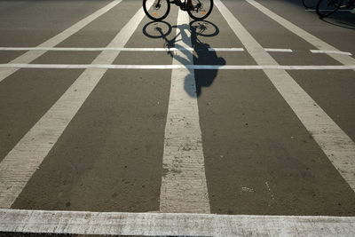 Shadow of a cyclist on the road.