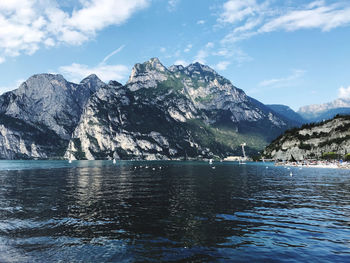 Scenic view of sea and mountains against sky