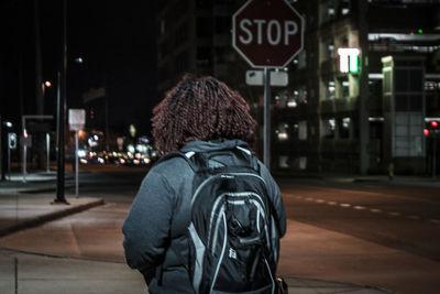 Rear view of woman in city at night