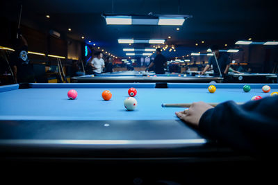 Cropped hand playing pool