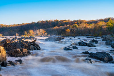 Scenic view of waterfall against sky